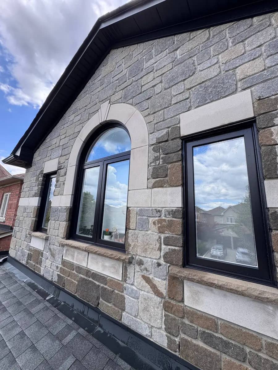 Clean black-framed windows on a stone GTA home, shared by customer David B. on Google