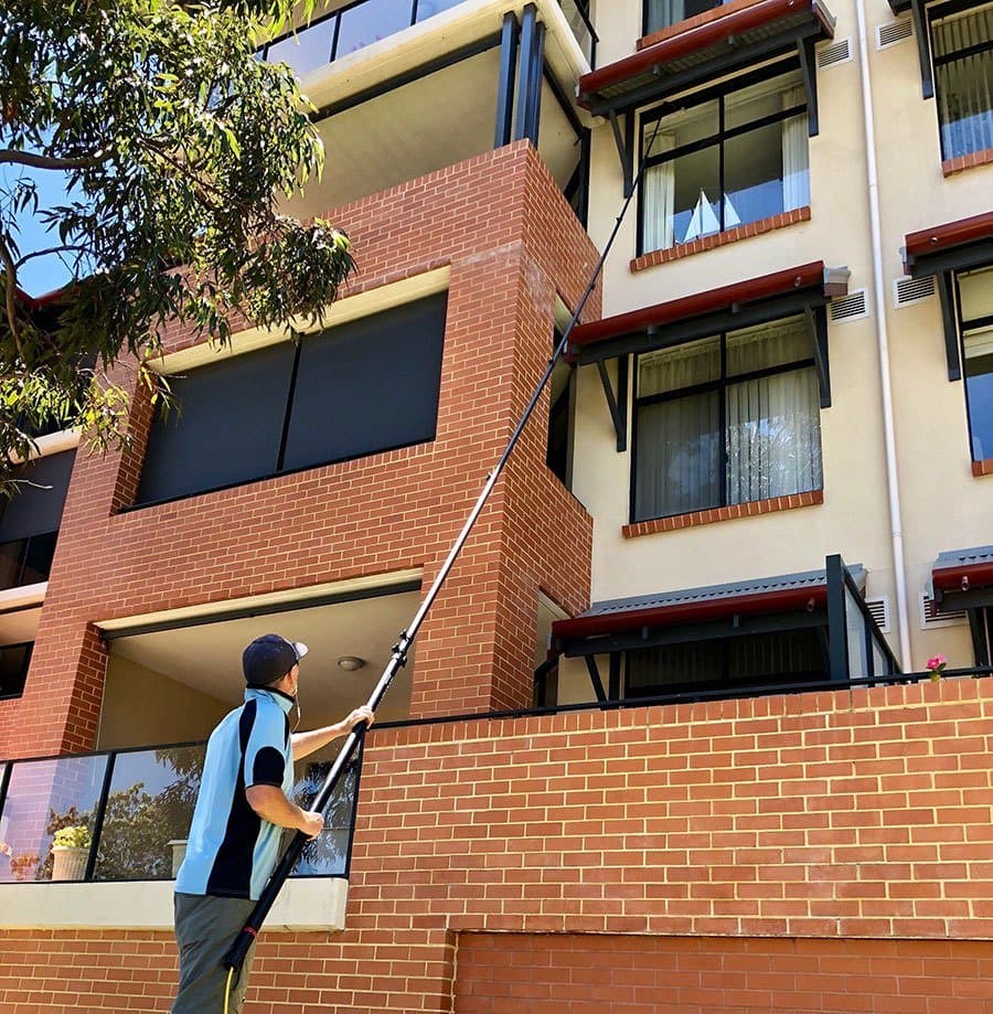Professional window cleaner at work